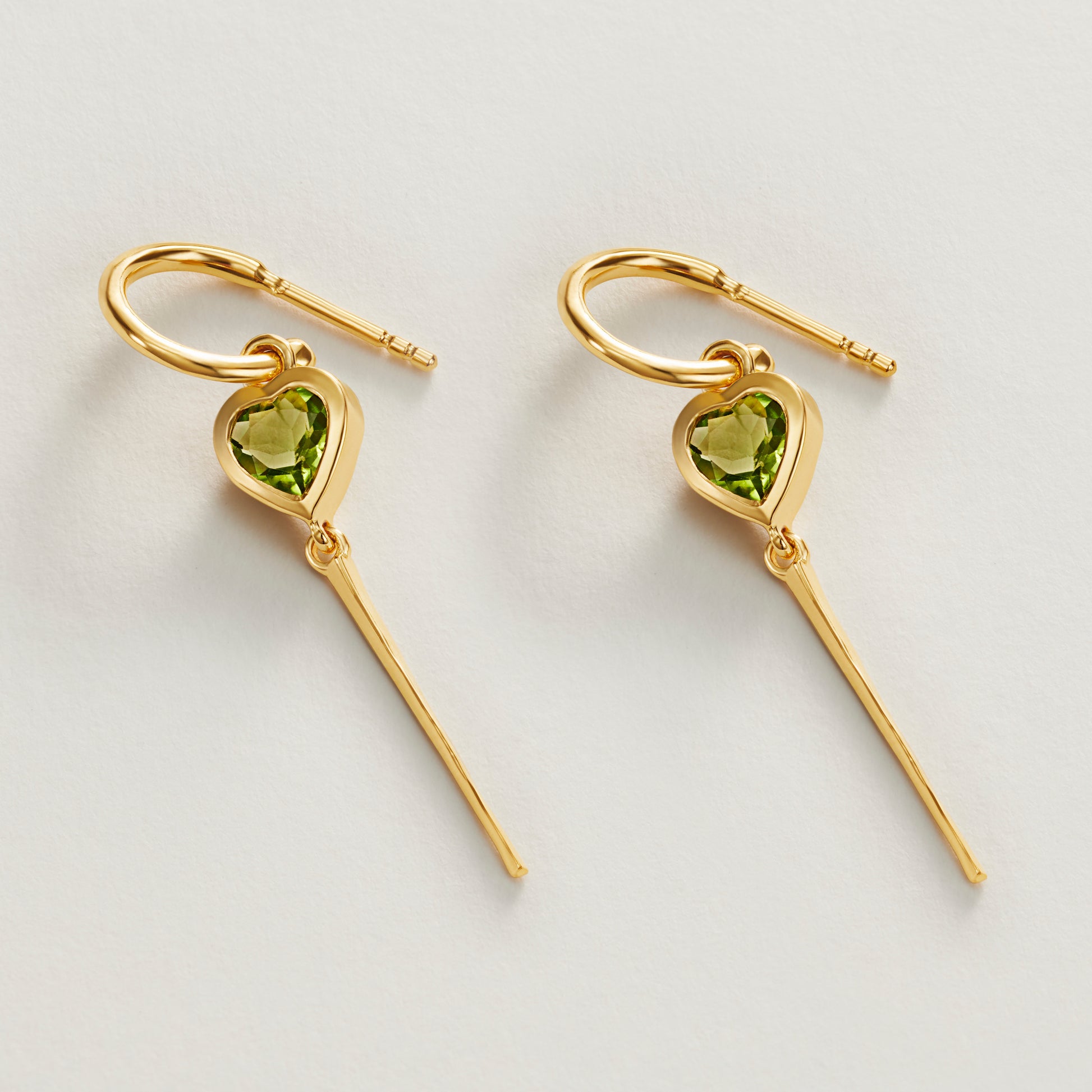 Peridot gemstone heart hoop drop earrings flatlay